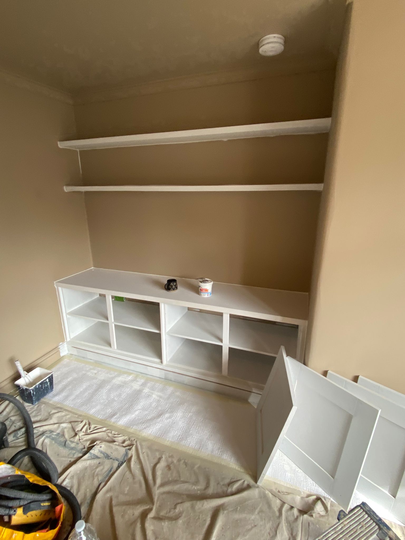 Blue-grey built-in cupboards with gold handles in an Edinburgh living room