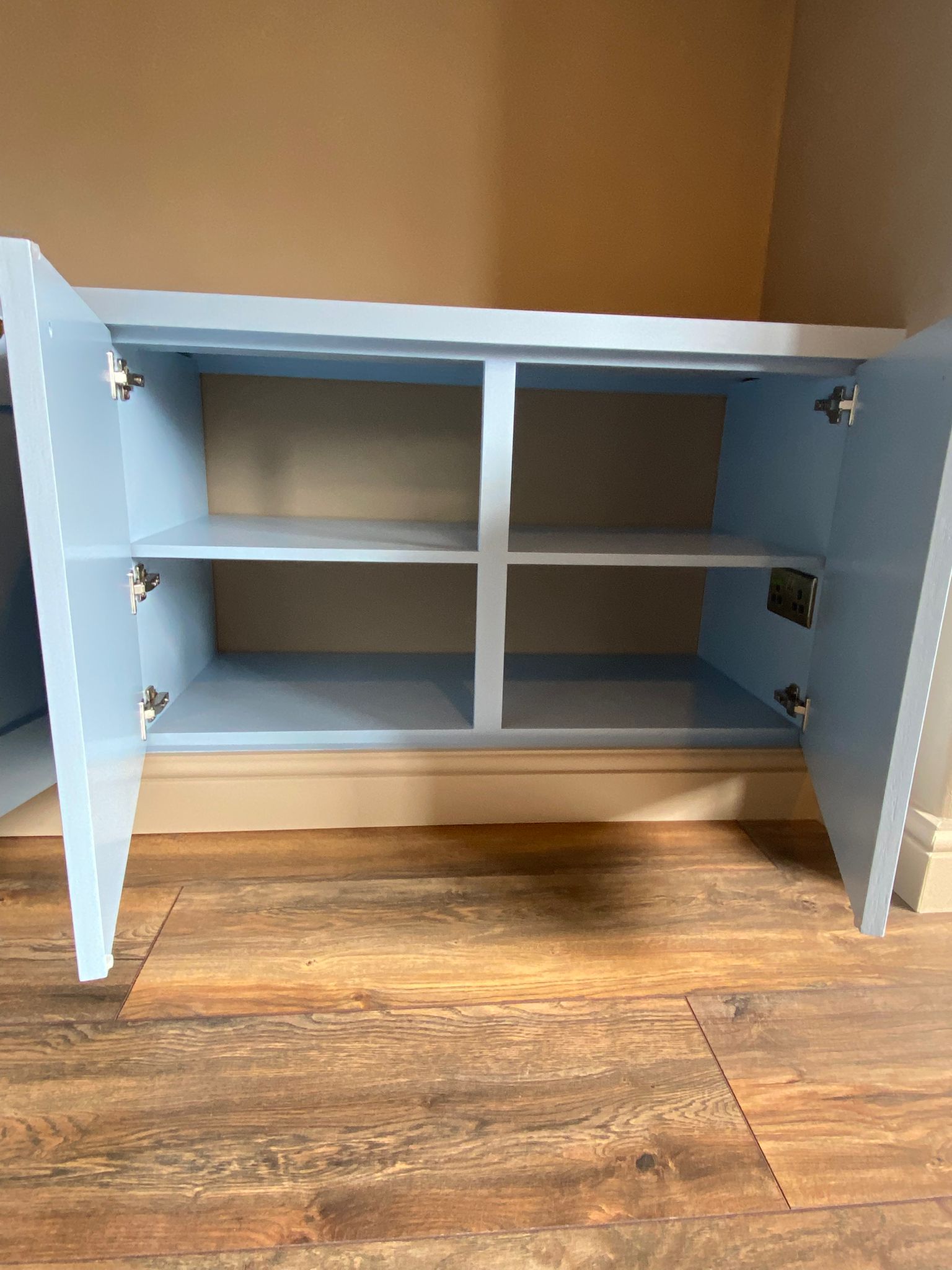 Finished built-in shelving and cupboard detail in an Edinburgh living room