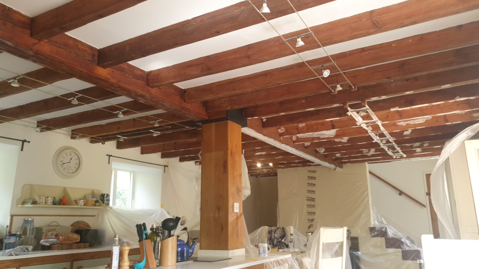 Exposed timber beams and protected kitchen during preparation